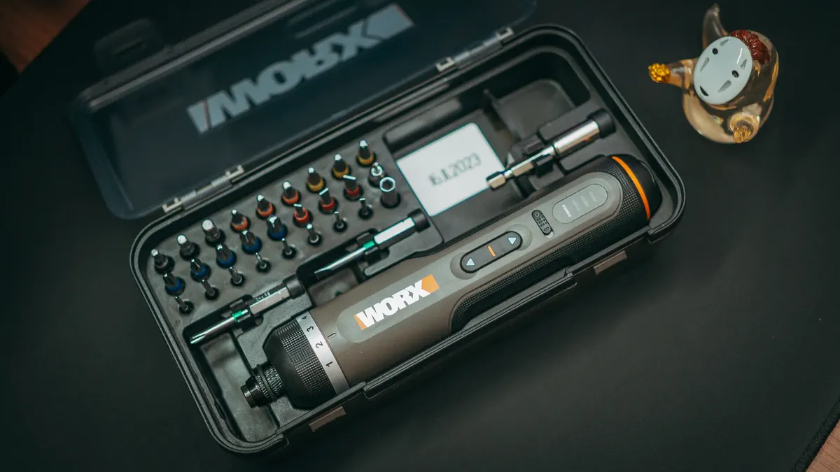 A portable electric screwdriver kit with various precision bits, ideal for tech repairs.