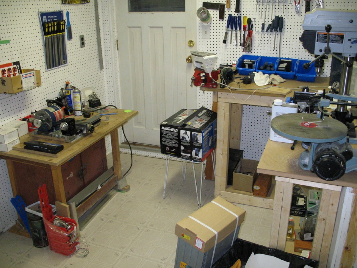 Workbench with tools, cloth, and oil container.