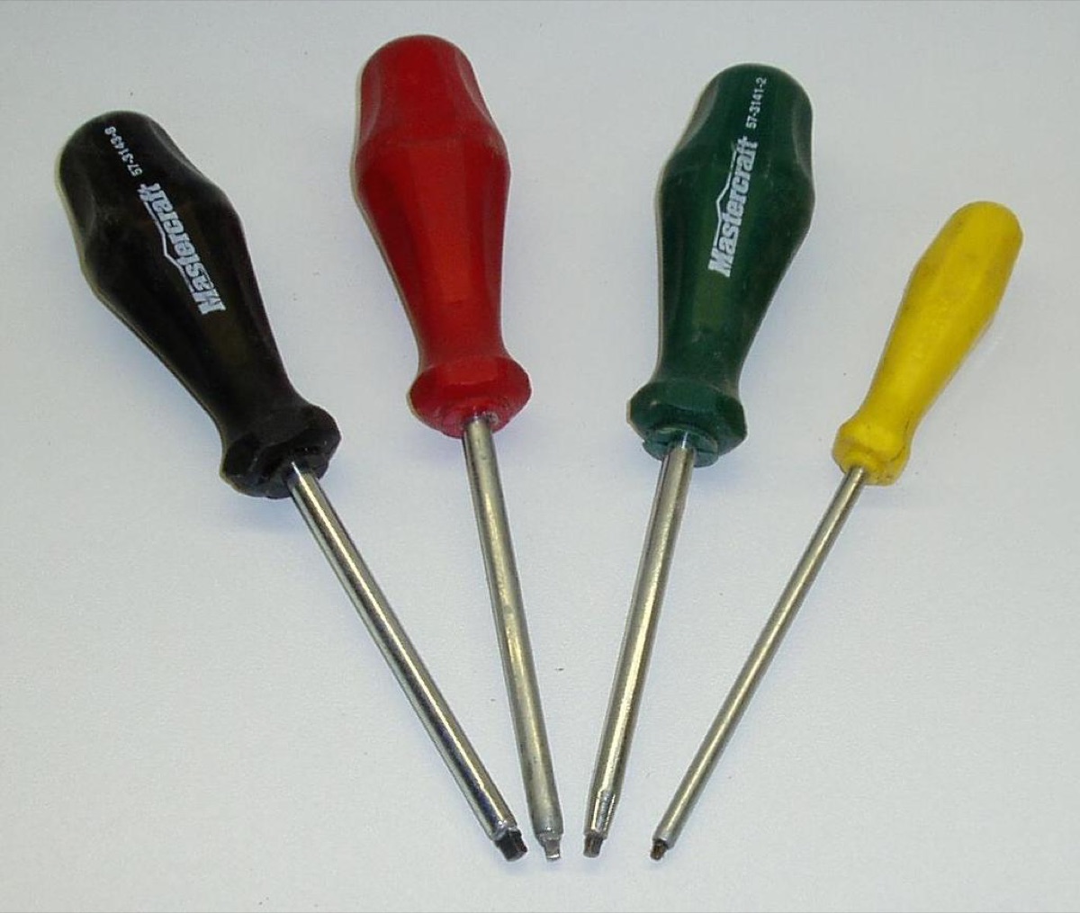 Screwdriver with rust spots on metal surface.